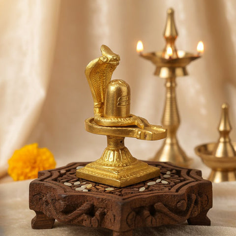 3.3-inch handcrafted brass Shivlingam with intricately designed Nag (serpent) surrounding the base, symbolizing divine energy and protection. The idol features detailed craftsmanship, ideal for worship, spiritual practices, or decorative display. India’s Largest Pooja Accessories Brand- www.satvikworld.com