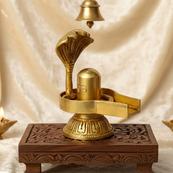 4.7-inch handcrafted brass Shivling with Sheshnaag, intricately crafted to symbolize Lord Shiva's divine presence and protection. The Sheshnaag wraps around the Shivling, representing spiritual power and purification. Ideal for worship, spiritual spaces, or home décor. India’s Largest Pooja Accessories Brand – www.satvikworld.com