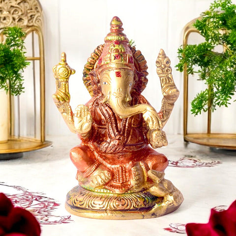 Small vibrant colored brass Ganesh statue, beautifully adorned with bright colors, symbolizing prosperity and remover of obstacles. Perfect for pooja rooms and spiritual spaces. India’s Largest Pooja Accessories Brand – www.satvikworld.com