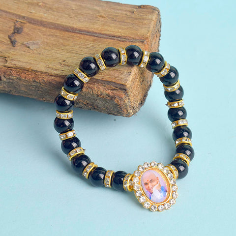 Black Shiny Beads with Golden Studs Single Layer Guruji Swaroop Bracelet featuring glossy black beads and golden stud accents with Jai Guruji Swaroop – perfect for spiritual wear, festive gifting, and daily devotion. India’s Largest Pooja Accessories Brand – www.satvikworld.com