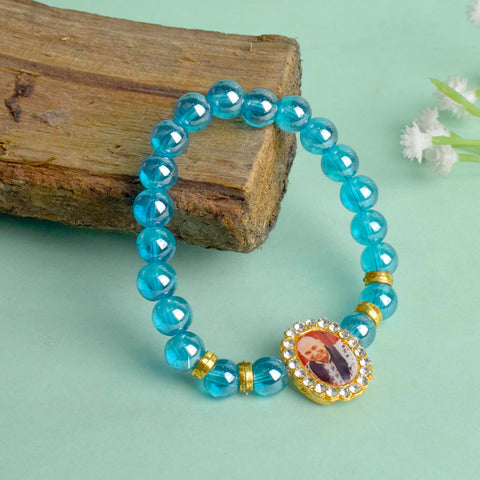 Blue Shiny Beads Single Layer Guruji Swaroop Bracelet featuring sparkling blue beads and Jai Guruji Swaroop – perfect for minimalist spiritual wear, meditation, and gifting. India’s Largest Pooja Accessories Brand – www.satvikworld.com