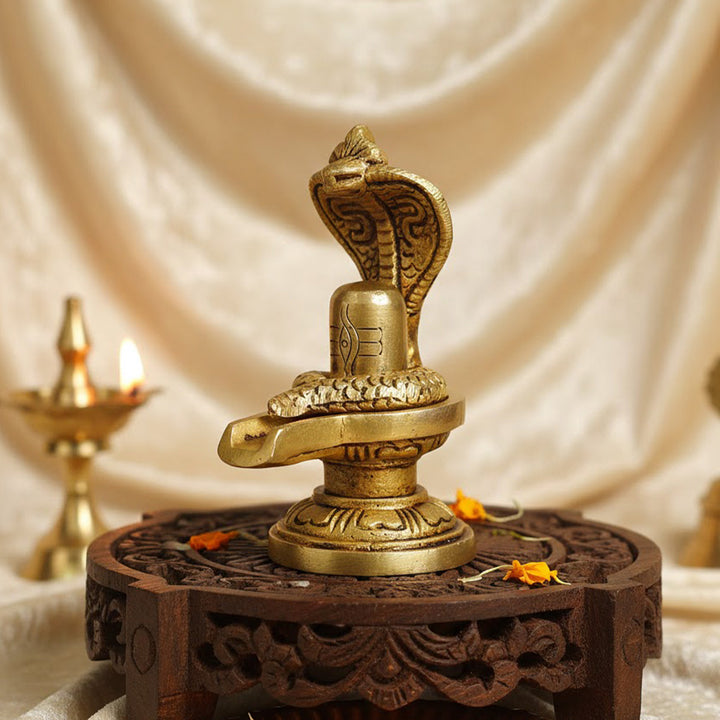 Elegant Brass Shivling with coiled Nag, symbolizing spiritual energy and protection, perfect for home worship and meditation. India’s Largest Pooja Accessories Brand – www.satvikworld.com