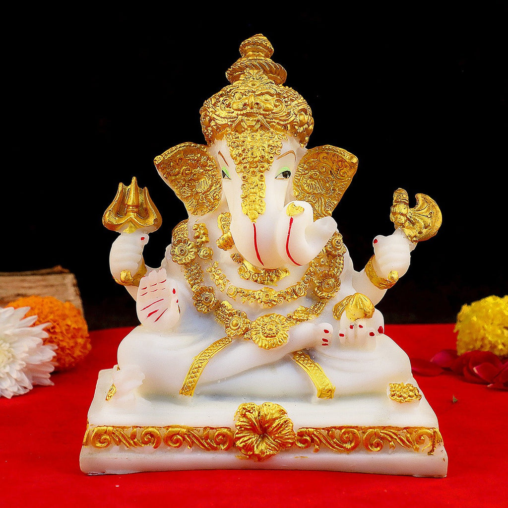 Divine seated Ganesh idol in resin, placed on an intricately designed decorative chowki, symbolizing wisdom, prosperity, and the removal of obstacles. Perfect for worship, gifting, or as a beautiful home décor piece. India’s Largest Pooja Accessories Brand – www.satvikworld.com