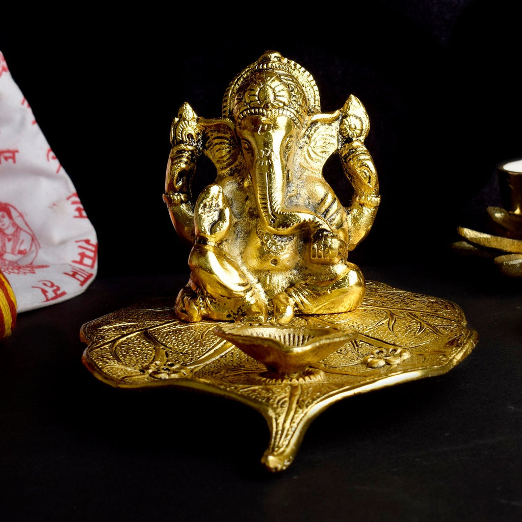 Handcrafted metal Ganesha idol with a diya, symbolizing divine blessings and light. Perfect for pooja rooms and spiritual spaces. India’s Largest Pooja Accessories Brand – www.satvikworld.com