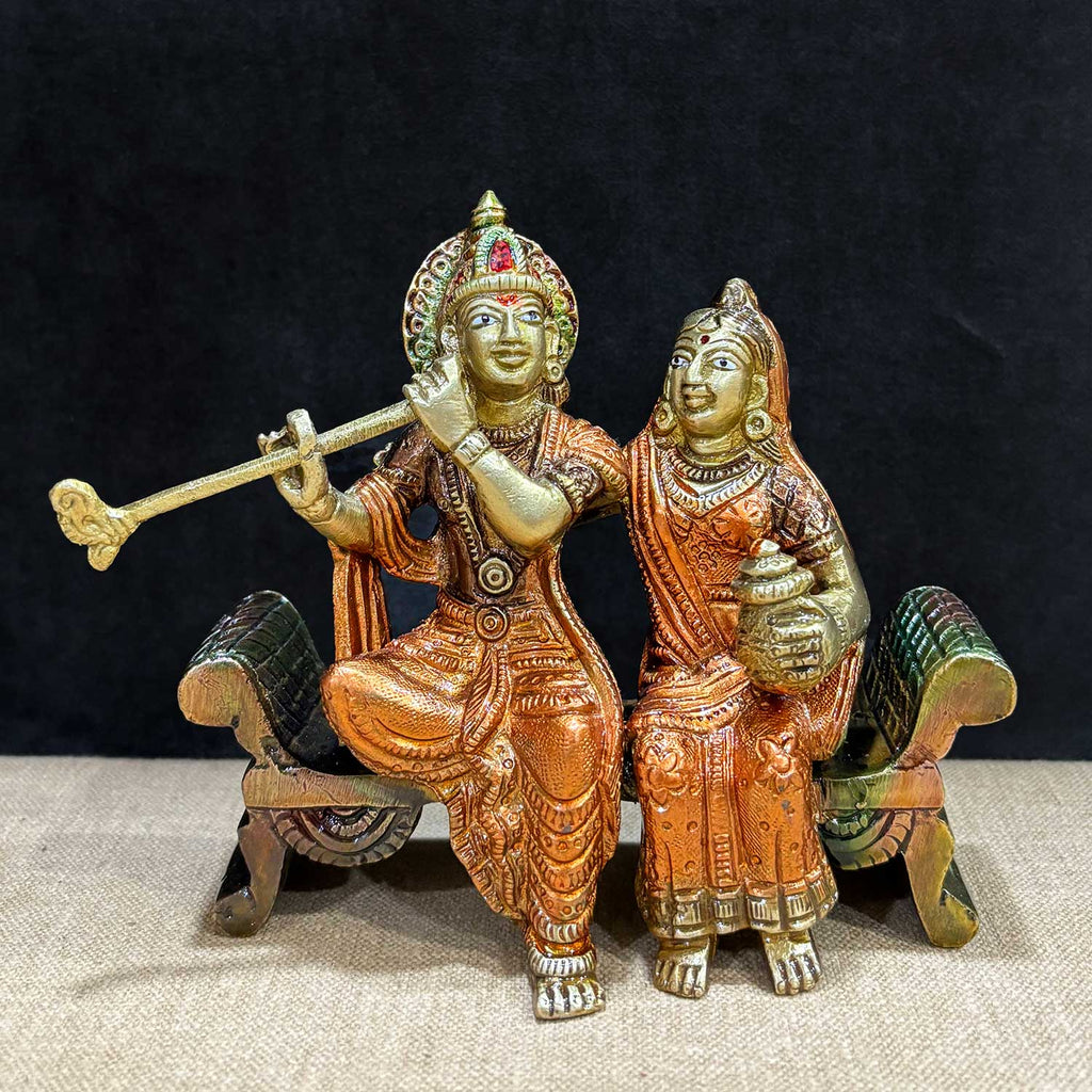 Graceful 4.7 inch brass idol of Radha and Krishna seated on a decorative bench, exuding divine charm and intricate detailing. A spiritual masterpiece in radiant finish. India’s Largest Pooja Accessories Brand – www.satvikworld.com