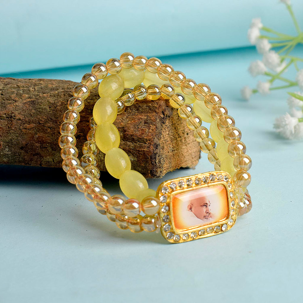 Golden Clear & Yellow Triple Layer Guruji Swaroop Bracelet featuring sparkling golden clear beads with bright yellow middle layer and Jai Guruji Swaroop – perfect for spiritual wear, meditation, and gifting. India’s Largest Pooja Accessories Brand – www.satvikworld.com
