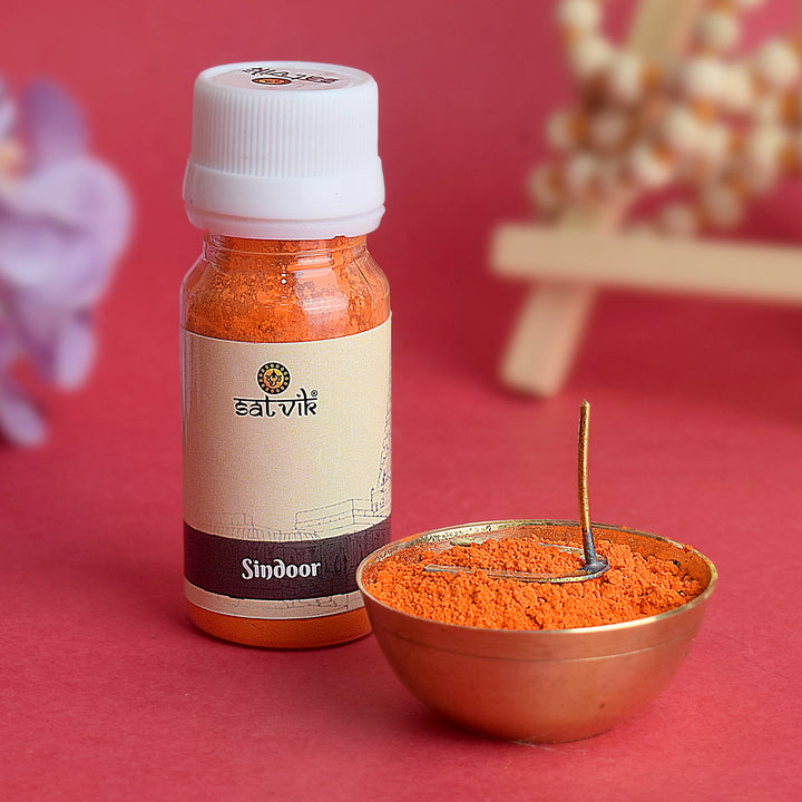 Bright red Sindoor powder in a container, traditionally used for worship of Hanuman Ji in Hindu rituals.India’s Largest Pooja Accessories Brand – www.satvikworld.com