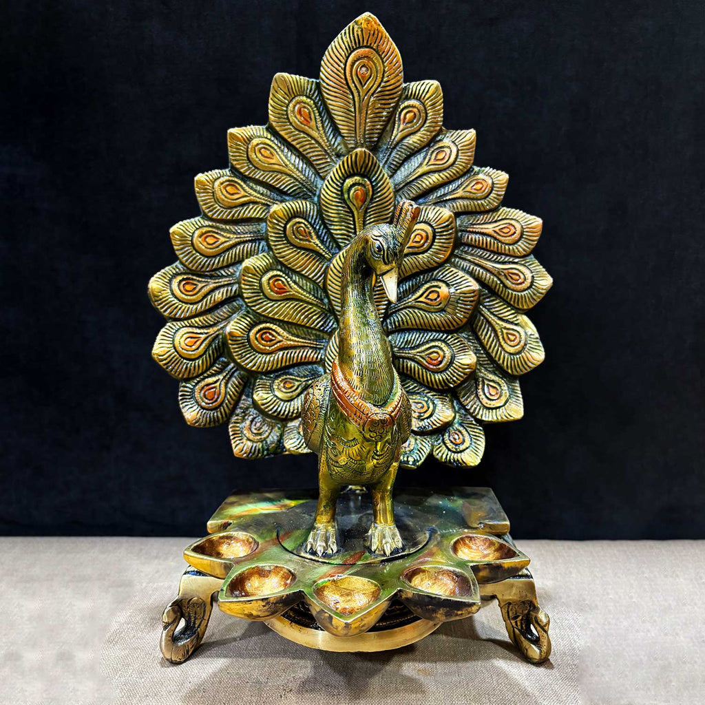 14.1 Inches Stylish Peacock Panch Diya made of premium brass, featuring five oil holders and an intricately designed peacock perched atop, ideal for festive pooja decor and traditional rituals. India’s Largest Pooja Accessories Brand – www.satvikworld.com