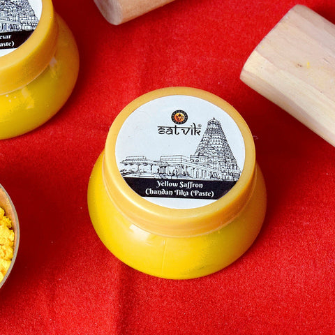 Yellow saffron Chandan Tika paste in a small container, ideal for applying tilak during Hindu rituals and spiritual ceremonies. India’s Largest Pooja Accessories Brand – www.satvikworld.com