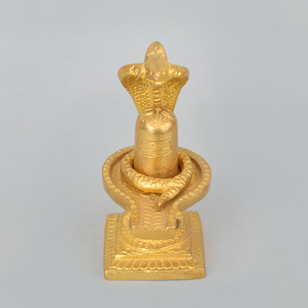 3.3-inch handcrafted brass Shivlingam with intricately designed Nag (serpent) surrounding the base, symbolizing divine energy and protection. The idol features detailed craftsmanship, ideal for worship, spiritual practices, or decorative display. India’s Largest Pooja Accessories Brand- www.satvikworld.com