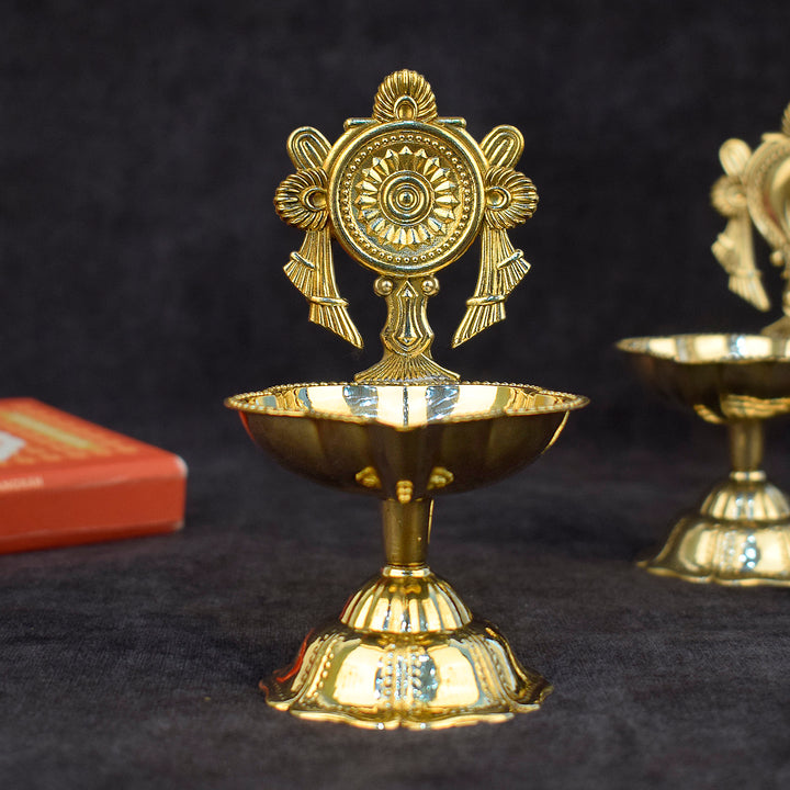 Intricately crafted designer chakra brass diya featuring a radiant circular pattern, ideal for traditional pooja rituals and festive home décor. India’s Largest Pooja Accessories Brand – www.satvikworld.com