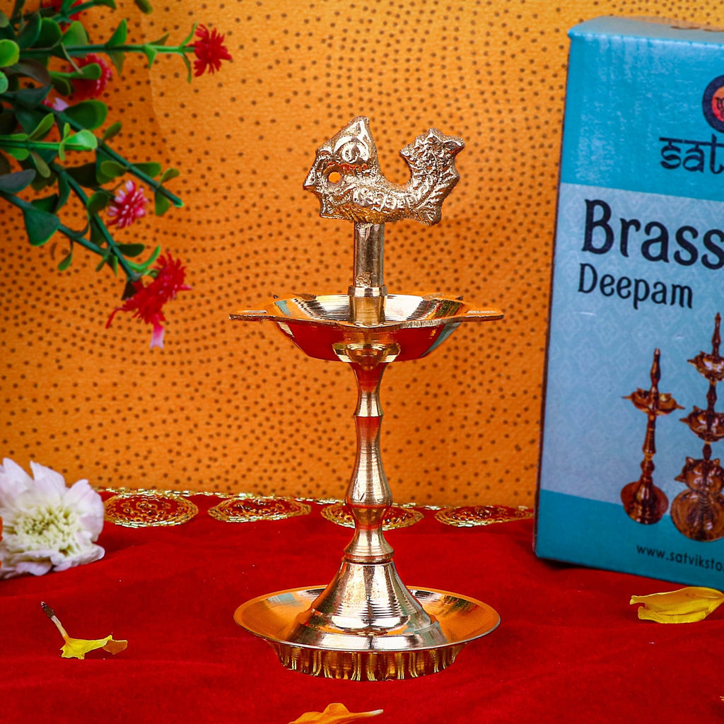 5.25 Inch Brass Peacock Kerala Diya – Elegant and compact brass diya with peacock design, perfect for pooja ceremonies, spiritual rituals, and home décor. India’s Largest Pooja Accessories Brand – www.satvikstore.in