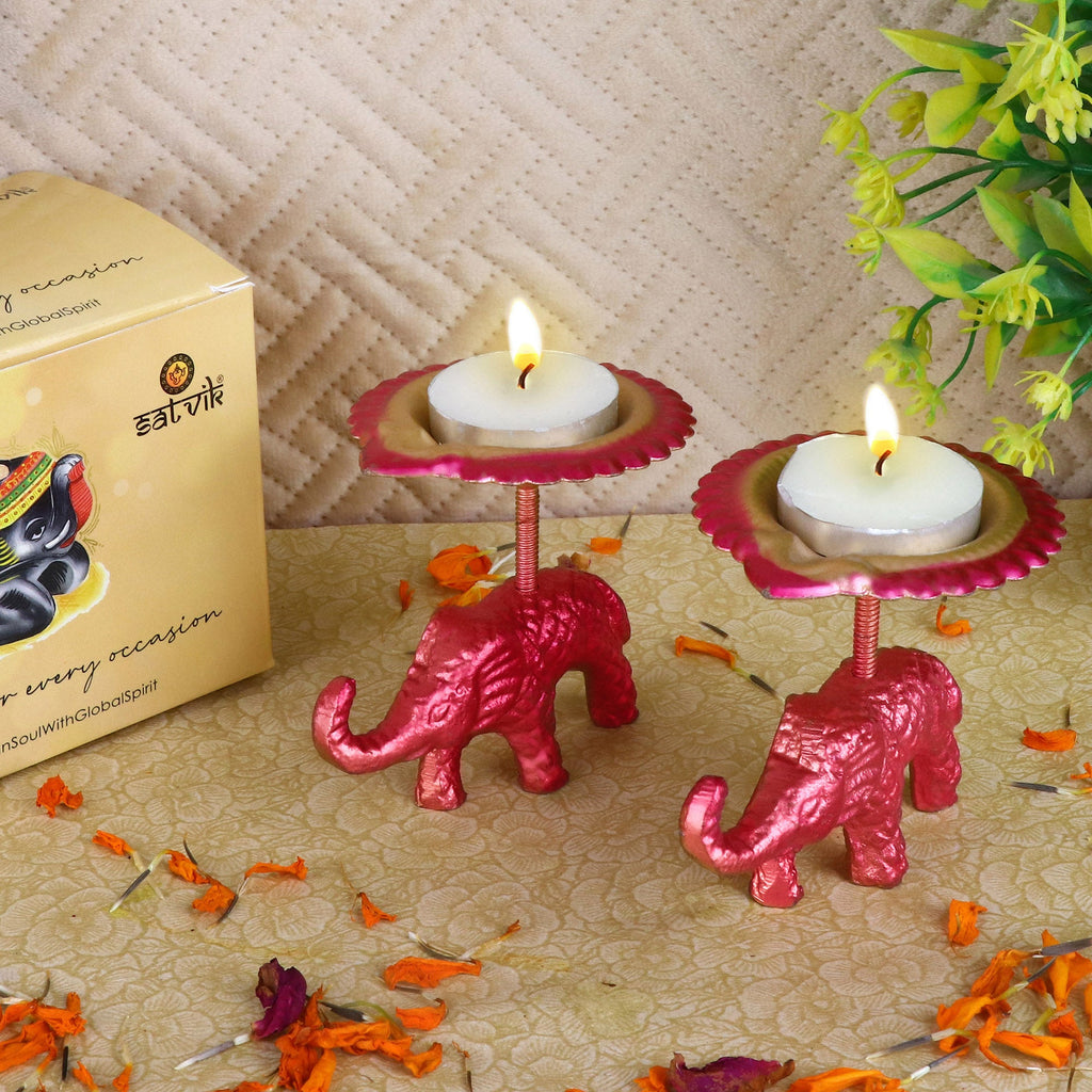Metal Elephant with Diya Showpiece Set of 2 – A finely crafted decorative metal set featuring two majestic elephant figures holding diya lamps, perfect for traditional home decor and festive celebrations. India’s Largest Pooja Accessories Brand – www.satvikworld.com